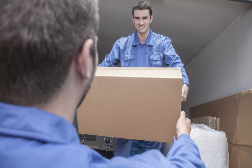 Furniture collection team handling a bulky item in a London home