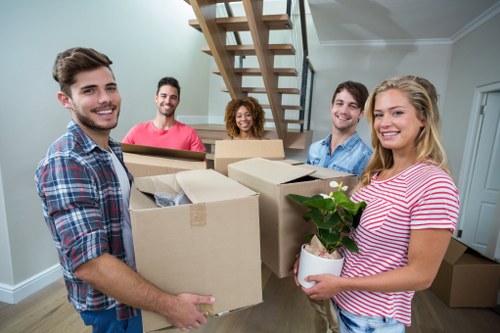 Packers handling boxes and furniture for a move