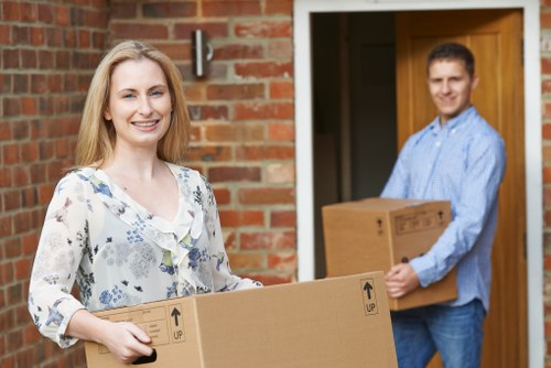 Removal team preparing items with safety awareness during a house move