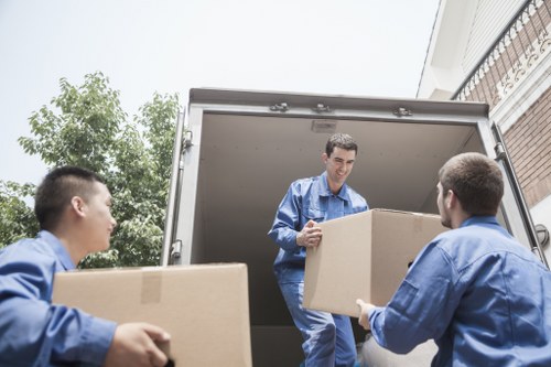 Professional movers loading furniture into a van
