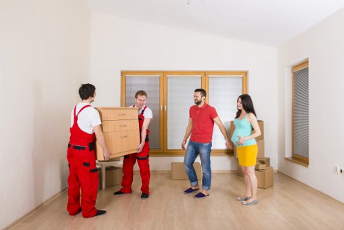 Moving team supporting a London house removal with boxes and furniture