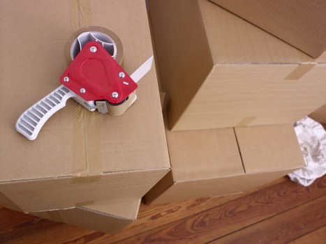Packed moving boxes and furniture ready for transport in London