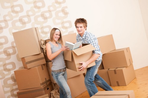 Local movers packing fragile items in a London property