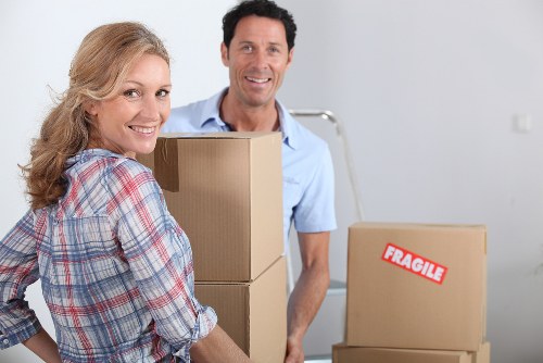 Removal van and moving crew in a residential London street
